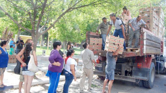En la plaza céntrica de Cipolletti hubo largas filas de vecinos, que aguardaron con paciencia para poder llevarse cajas de peras de exportación que no pudieron comercializarse.